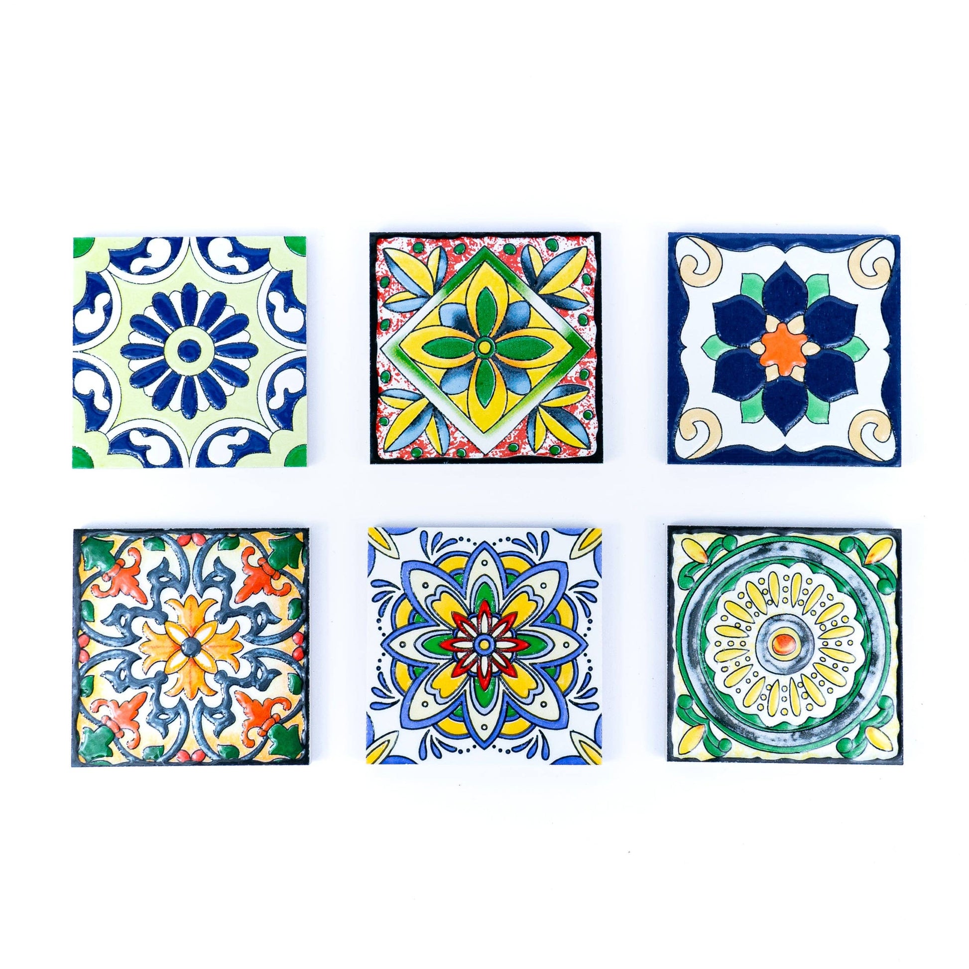 The Meninas Bonitas Cork Tile-Inspired Ceramic & Cork Coasters (Set of 6) feature colorful geometric and floral designs, capturing the charm of traditional Portuguese tiles. Arranged neatly, each piece adds a vibrant touch to your table.