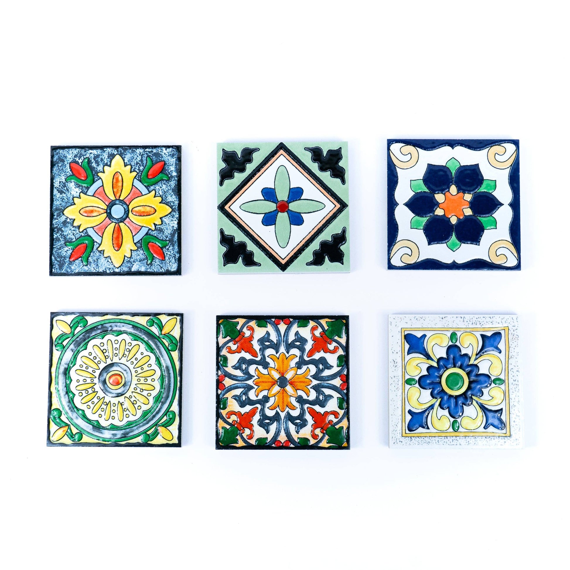 The Tile-Inspired Ceramic & Cork Coasters - Set of 6 by Meninas Bonitas Cork features six unique coasters with colorful floral and geometric patterns in blue, yellow, green, orange, and red. Each coaster combines vibrant azulejo-inspired designs.