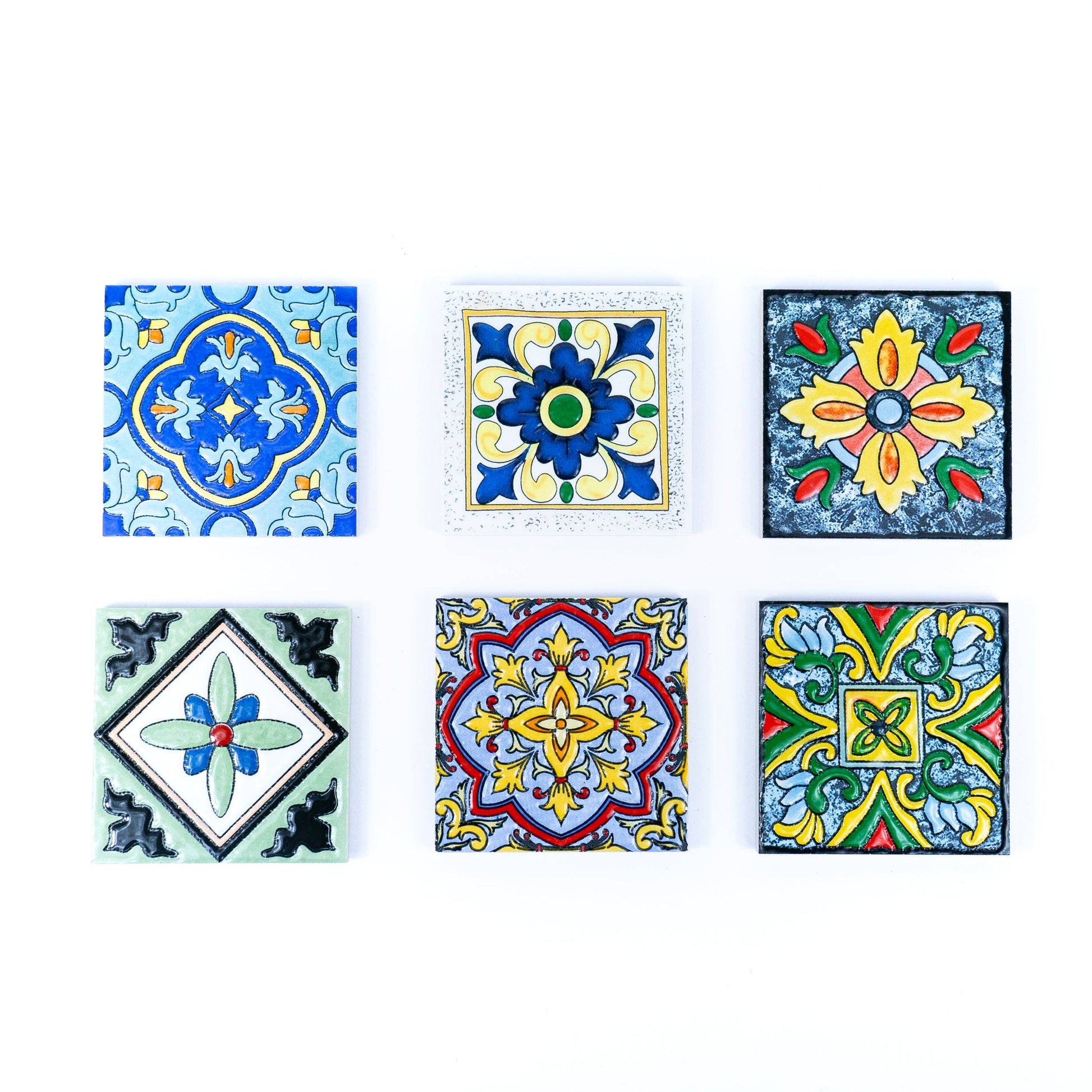 The Meninas Bonitas Cork Tile-Inspired Ceramic & Cork Coasters set includes six coasters with vibrant, symmetrical patterns in blue, yellow, green, red, and black, arranged in two rows of three on a white background.