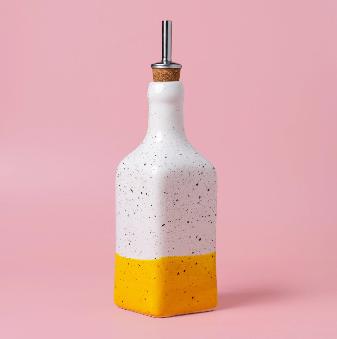 The Salad kit | CANELA Oil and Salad Bowl by Alfar Tierra Cocida features a ceramic bottle with a speckled white top, solid yellow bottom, and metal pour spout with cork. A stylish handmade addition to your kitchen or olive oil pourer set.