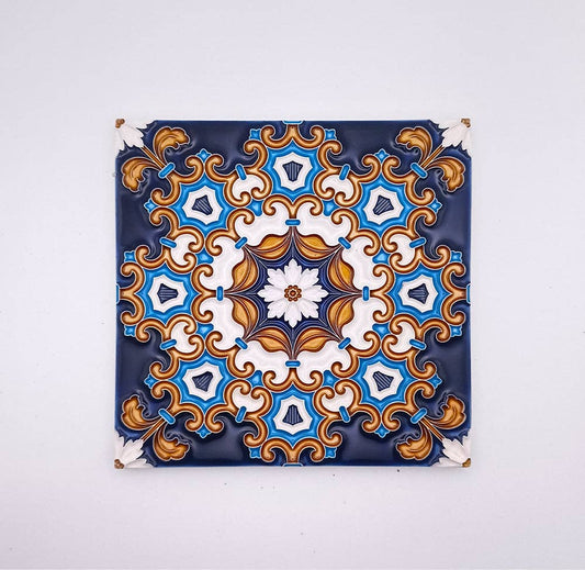 The Tejo Shop Decorative Drop Ceiling Tiles showcase an intricate, symmetrical pattern in blue, white, and gold on a dark background, inspired by traditional Portuguese tiles for a vintage touch.