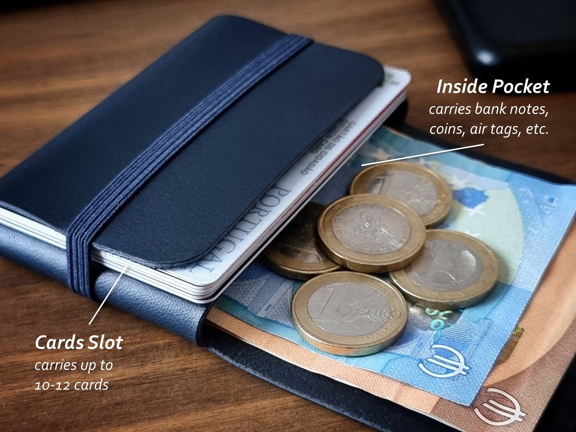 The Singular Leather Marine Blue Leather Wallet, crafted from genuine leather, sits on wood and holds euro notes, coins, and up to 10-12 cards. Labels highlight pockets for notes, coins, AirTags, RFID protection, and a card slot.