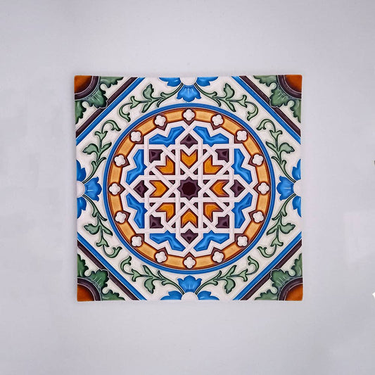 The Tejo Shop Mosaic Decorative Wall Tiles showcase a handcrafted ceramic tile with a detailed blue, green, orange, and brown geometric floral pattern—ideal as mosaic wall or backsplash tiles—on a plain light gray background.