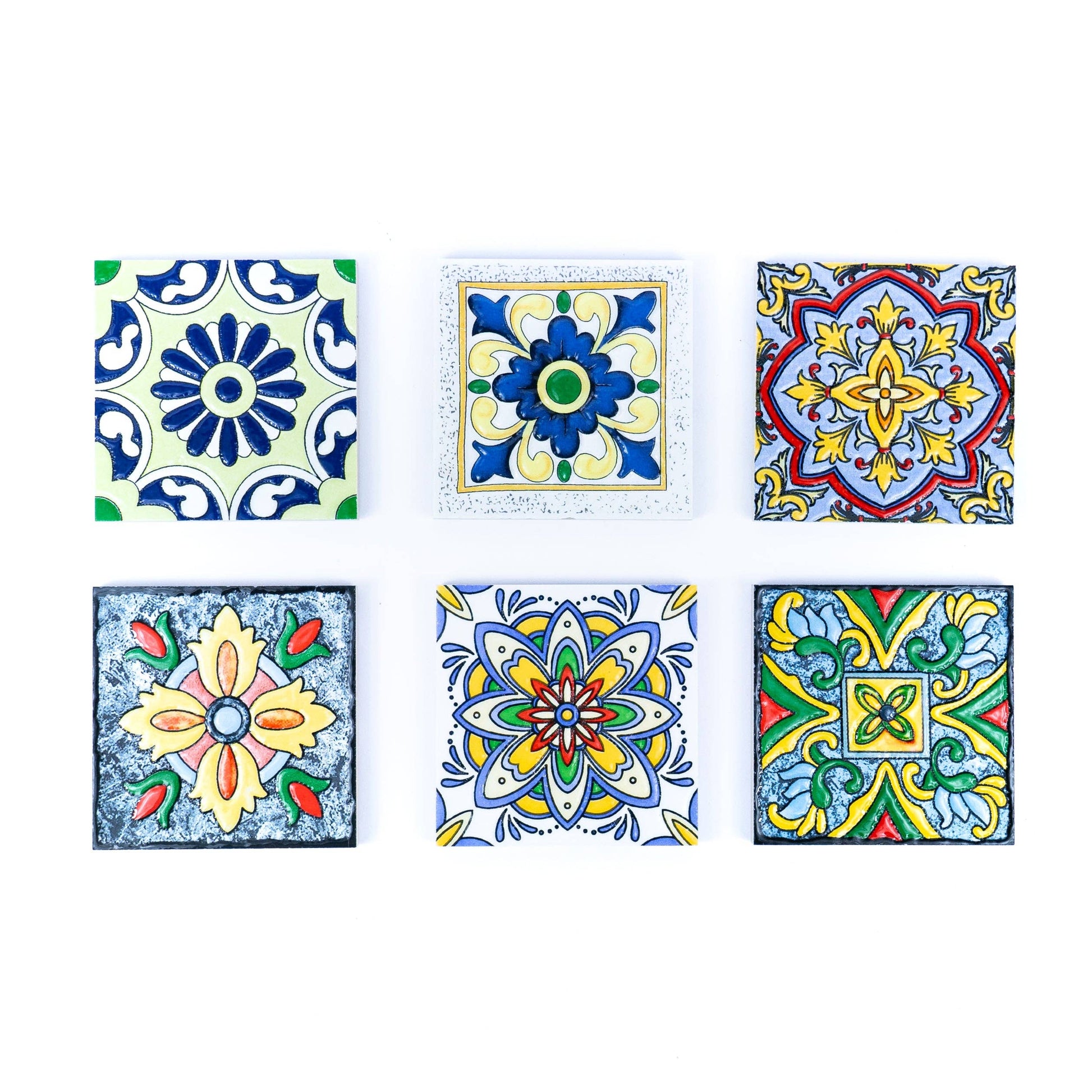 The Meninas Bonitas Cork Tile-Inspired Ceramic & Cork Coasters set includes 6 coasters, each with vibrant blue, yellow, green, and red geometric and floral designs inspired by Portuguese tiles.
