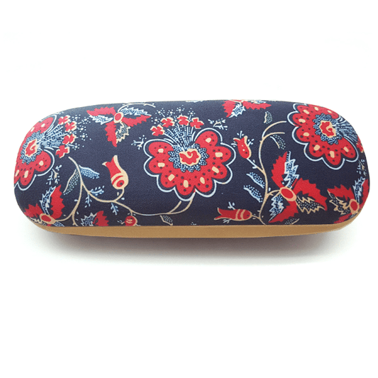 The “Chita” Glasses Case by Terra Lusa features a navy background with red and white floral patterns inspired by Portuguese heritage and tan edges, shown from a top view.