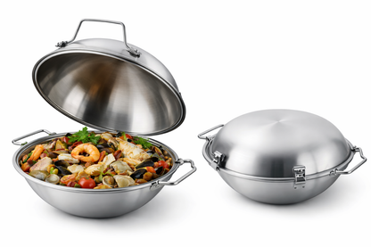 The Silampos Cataplana 36cm - Stainless Steel, a classic Portuguese pan, is shown open and filled with seafood paella with shrimp, clams, mussels, and vegetables. Another closed identical cataplana sits beside it, both featuring sturdy handles and clasps.