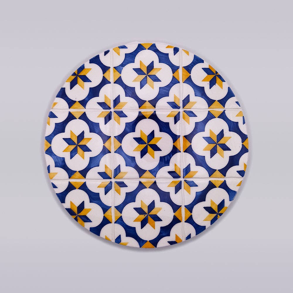 blue and yellow ceramic trivet