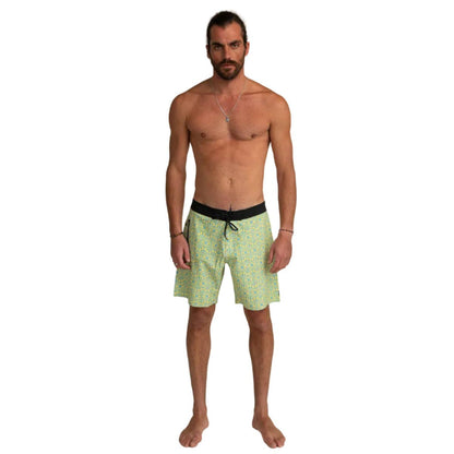 Man wearing Futah Flora Yellow Boardshorts with black waistband and drawstring