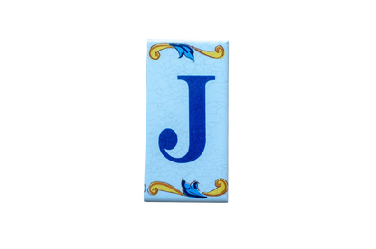 Lisa Croquets Letters – Ceramic House Letter Tile featuring a rectangular blue letter J with decorative yellow and blue scrollwork at the top and bottom.