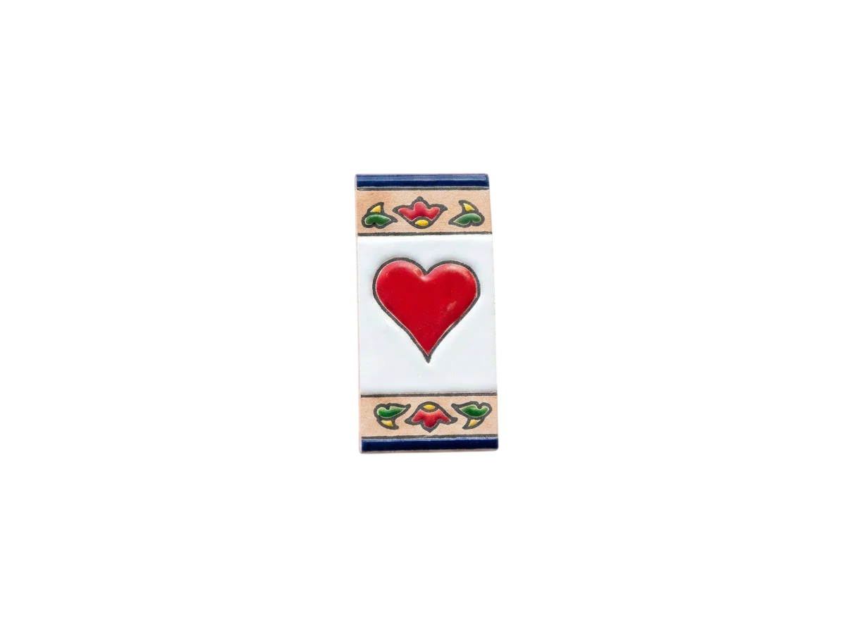 Mini Chilli Ceramic House Number & Letter Tile featuring a red heart in the center with a decorative floral border at the top and bottom in the style of handcrafted Spanish tiles.