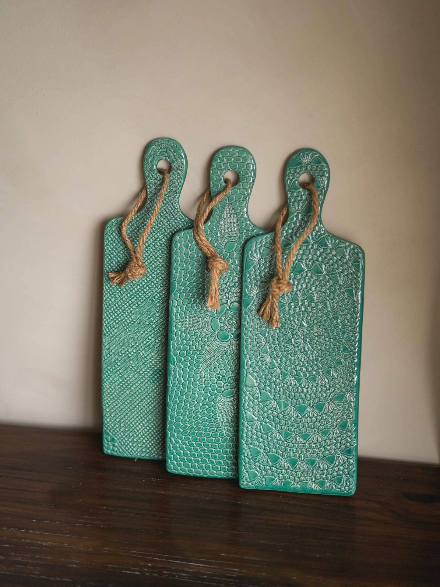 3 blue crafted porcelain boards with crochet pattern